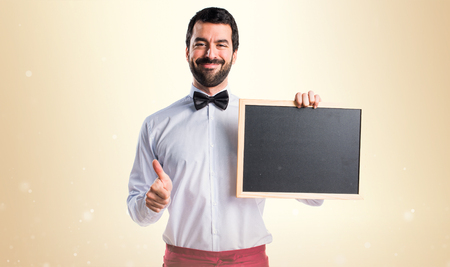 Waiter holding an empty placardの写真素材
