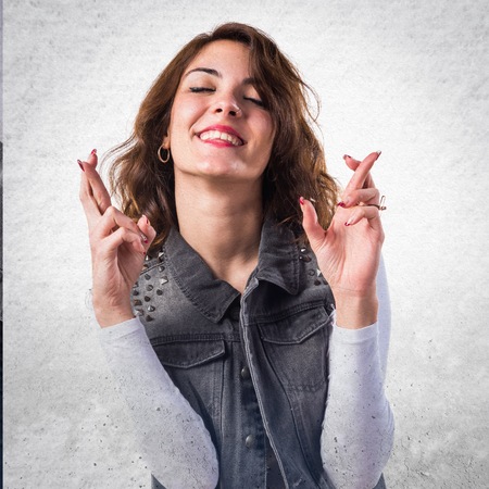 Woman with her fingers crossingの写真素材