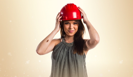 Young worker woman with red hatの写真素材