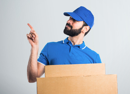 Delivery man thinkingの写真素材