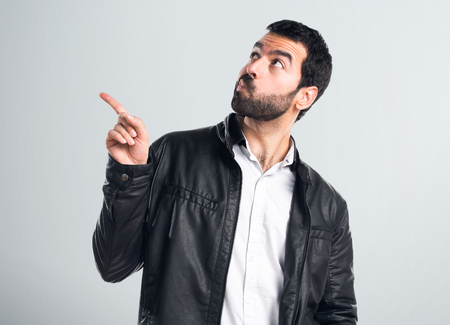 Man with leather jacket thinkingの写真素材