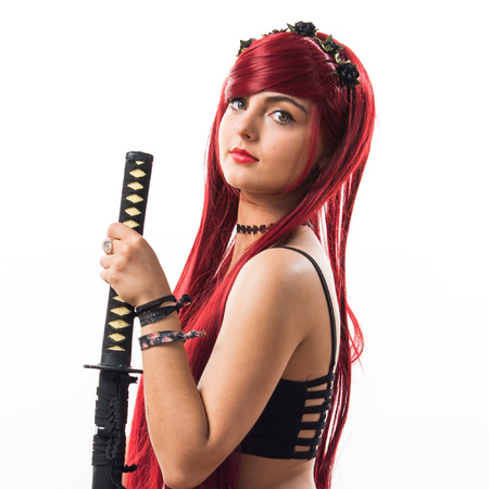 Young redhead girl with katanaの写真素材