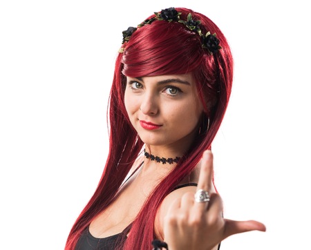 Young redhead girl making horn gestureの写真素材