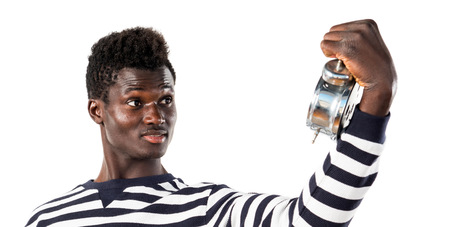 Handsome black man holding vintage clockの写真素材