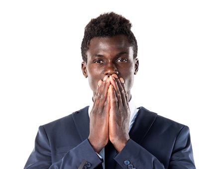 Handsome black man covering his mouthの写真素材