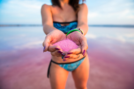 Pretty woman with holi colours in a colorful lakeの写真素材