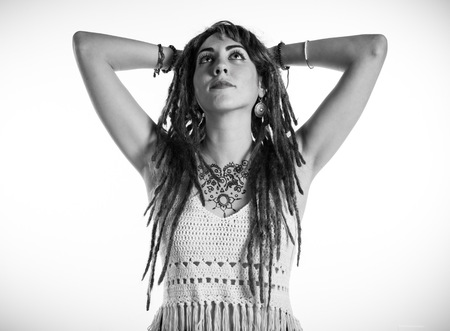 Tattooed girl with dreadlocks posing in studioの写真素材