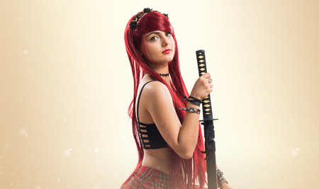 Young redhead girl with katanaの写真素材