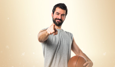 Man playing basketball pointing to the frontの写真素材