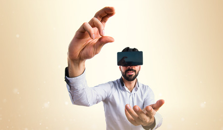Man using VR glasses holding somethingの写真素材
