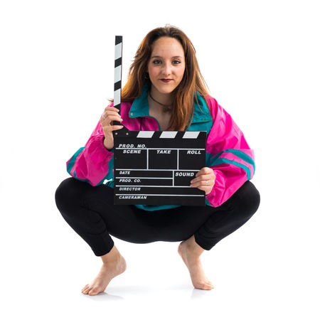 Young woman holding a clapperboardの写真素材