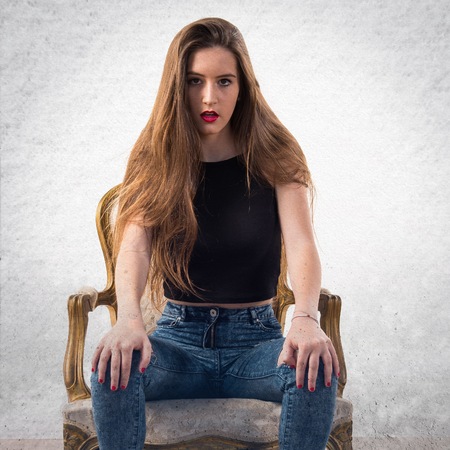 Young girl on vintage armchairの写真素材