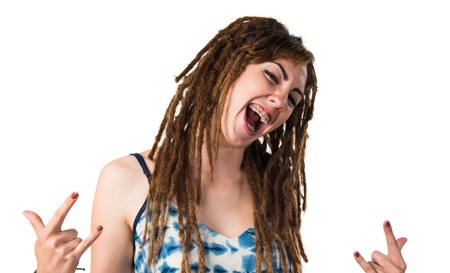 Girl with dreadlocks making horn gesture