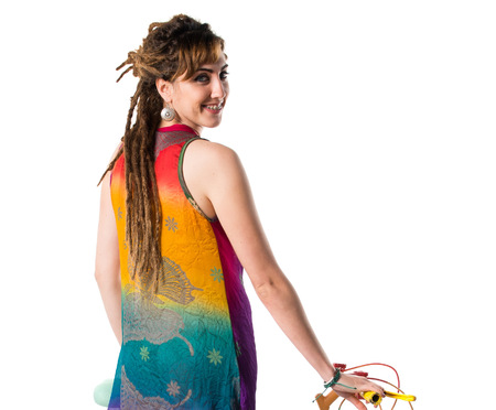 Girl with dreadlocks on colorful bikeの写真素材