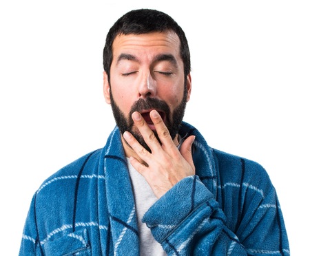 Man in dressing gown yawningの写真素材