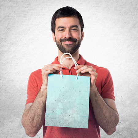 Handsome man with shopping bagの写真素材