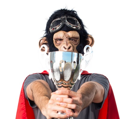 Superhero monkey man holding a trophyの写真素材