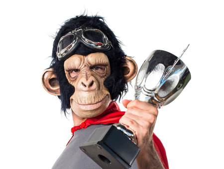 Superhero monkey man holding a trophy