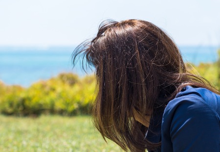 Beautiful woman posing in a park in from the beachの写真素材
