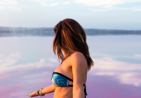 Pretty woman in a colorful lakeの写真素材