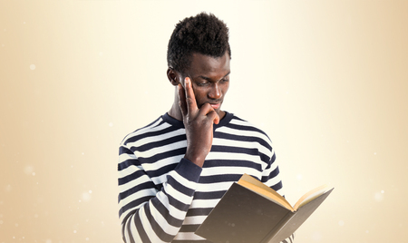 Handsome black man reading bookの写真素材