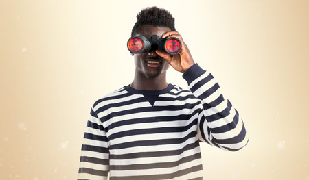 Handsome black man with binocularsの写真素材