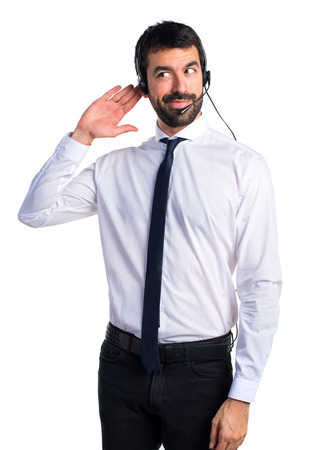 Handsome telemarketer man listening somethingの写真素材