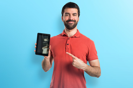 Handsome man holding a tabletの写真素材