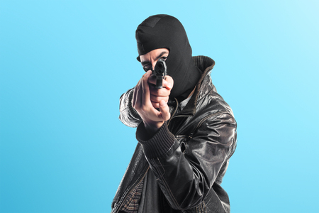 Robber shooting with a pistolの写真素材