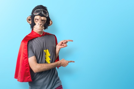 Superhero monkey man pointing to the lateralの写真素材
