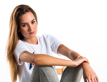 Blonde girl posing on chairの写真素材