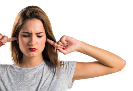 Young girl covering her ears