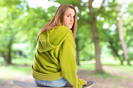 Pretty young girl wearing urban style with skateboardの写真素材