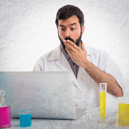 Surprised scientist man working with his laptopの写真素材