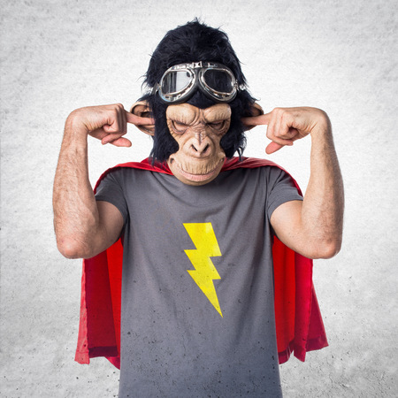 Superhero monkey man covering his earsの写真素材