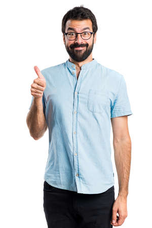 Handsome man with blue glasses with thumb upの写真素材