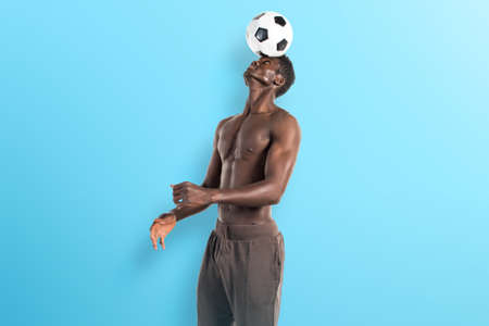 Black man playing footballの写真素材