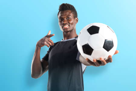 Black man playing footballの写真素材