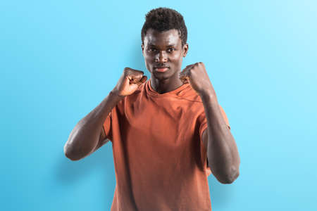 Strong black man giving a punchの写真素材