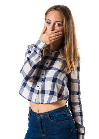 Blonde teen girl covering her mouthの写真素材