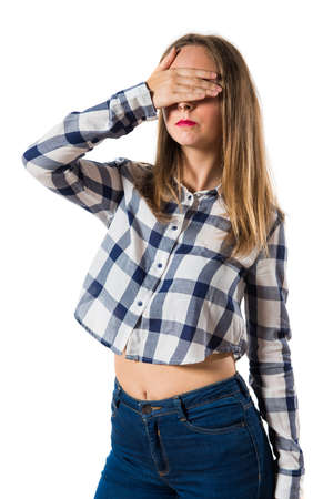 Blonde teen girl covering her eyesの写真素材