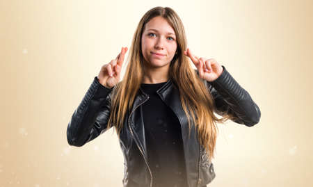 Teen girl with her fingers crossingの写真素材