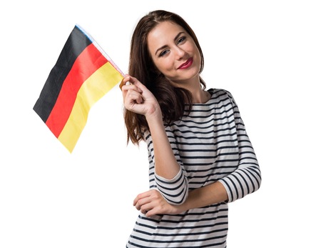 Pretty young girl holding a germany flagの写真素材