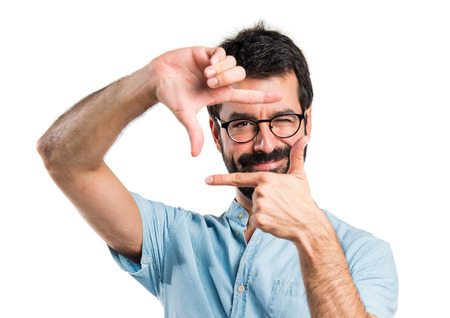 Handsome man focusing with his fingersの写真素材