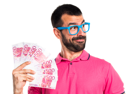 Man with colorful clothes taking a lot of moneyの写真素材