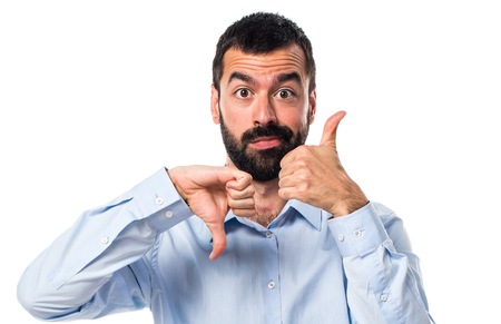 Handsome man making good-bad sign