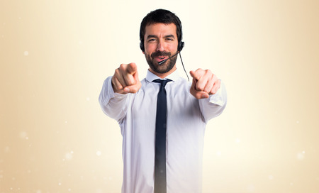 Young man with a headset pointing to the frontの写真素材