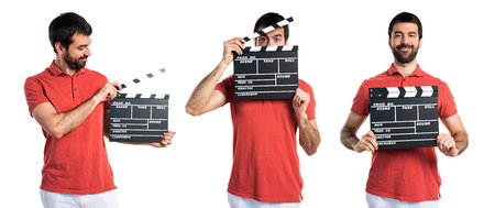 Handsome man holding a clapperboardの写真素材