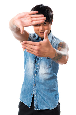 Asian handsome man focusing with his fingersの写真素材