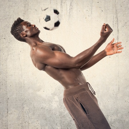 Black man playing footballの写真素材